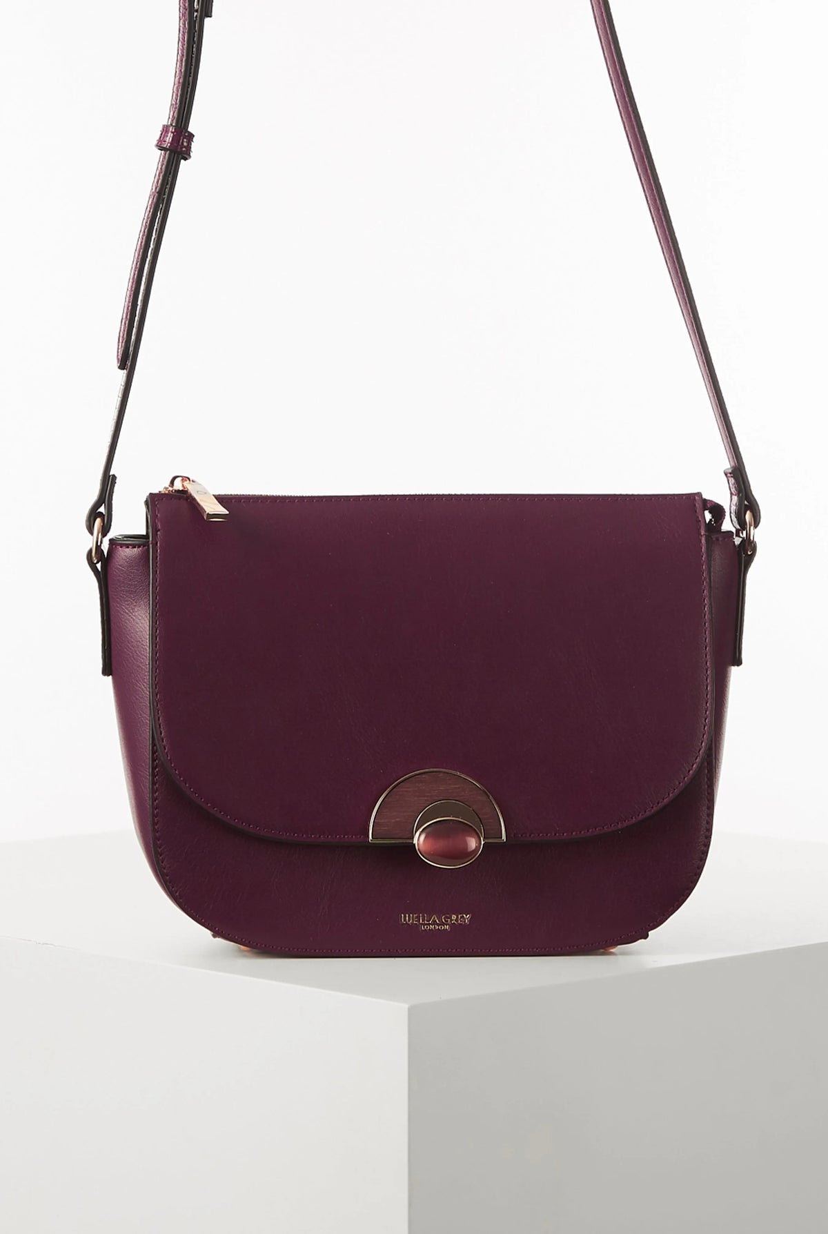 Berry leather crossbody bag with curved flap and gold turn-lock, side straps
