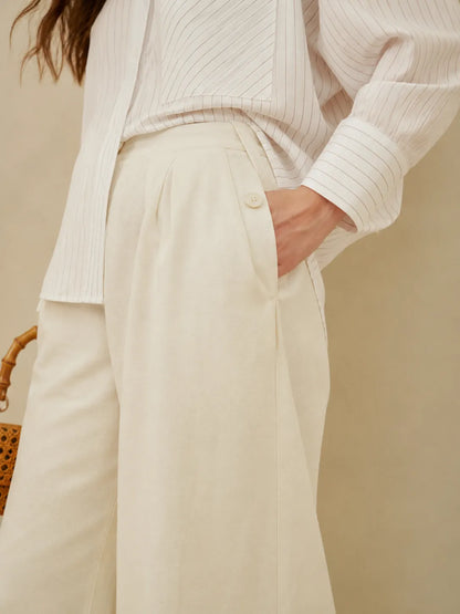 White wide-leg trousers with button waistband and front pleats