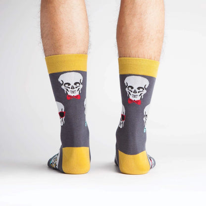 Skull-print crew socks, dark gray with yellow cuffs; red tongue and teal details