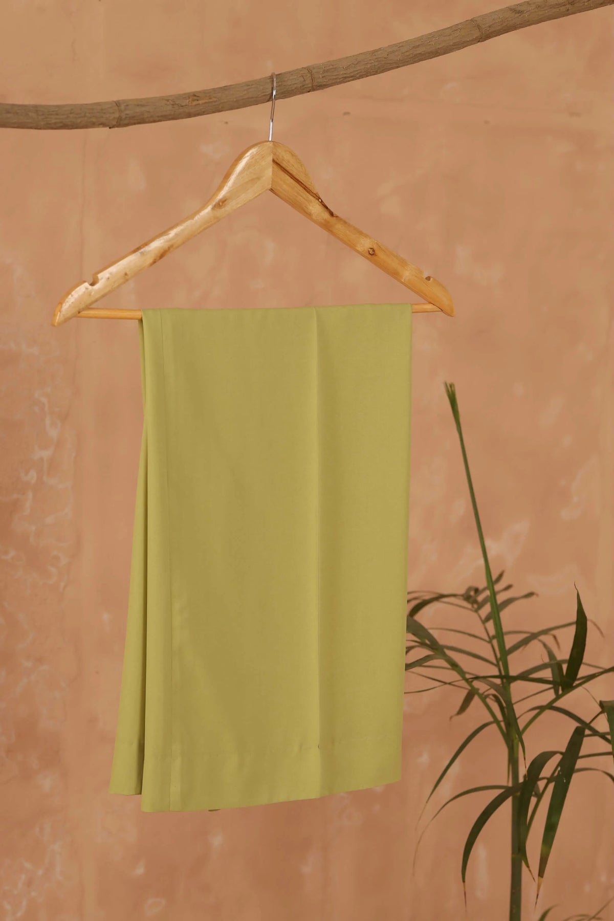 Pistachio solid slip-style tunic dress, sleeveless, hanging on wooden hanger