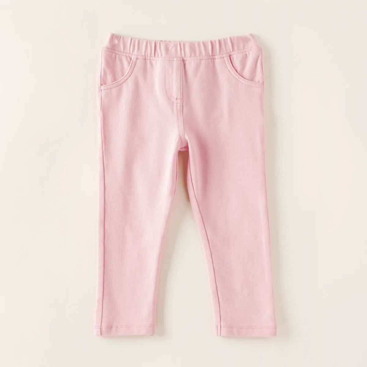 Pink baby pants with elastic waistband and curved back pockets