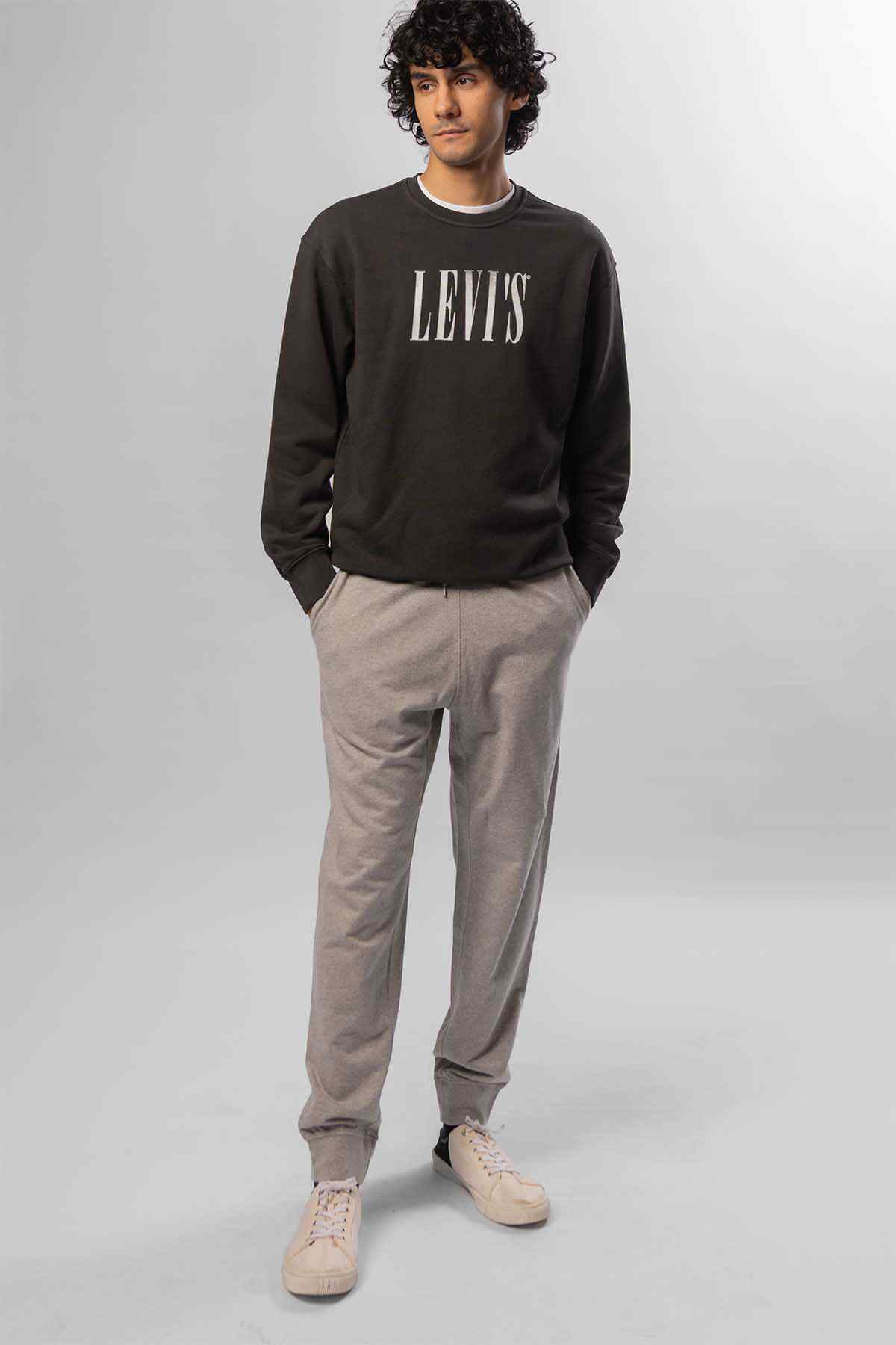 Levi's logo crewneck sweatshirt and light grey tapered jogger pants, front view
