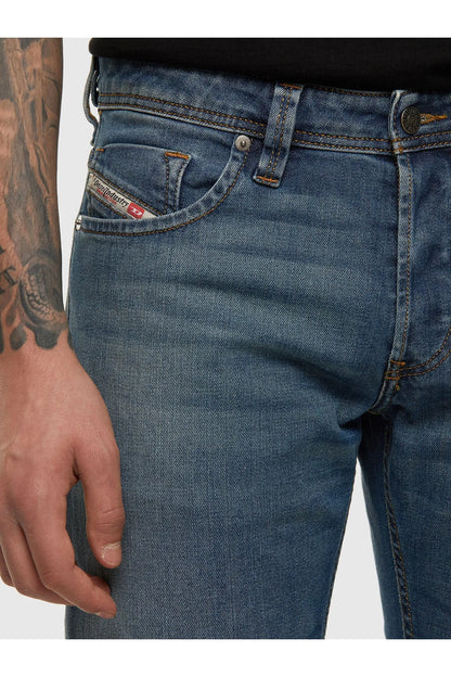 Blue denim jeans with button fly, stitched front pocket and coin pocket