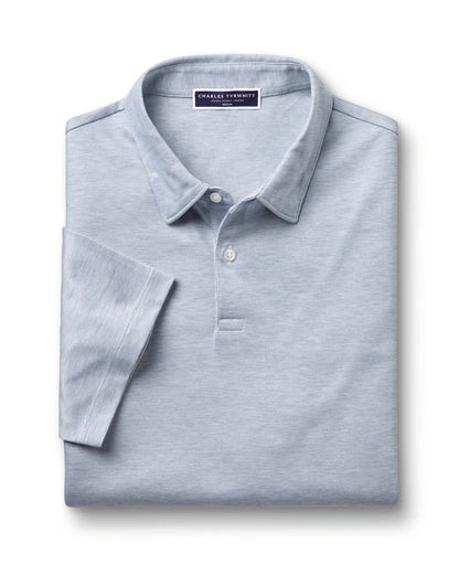 Light blue polo shirt flat lay with button placket and brand label