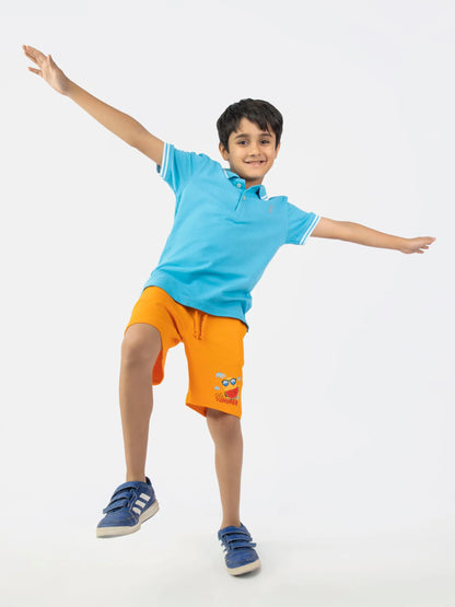 Light blue polo shirt with striped collar, paired with orange shorts