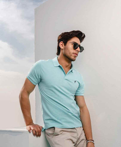 Light blue fitted polo shirt, short sleeves, collar, small chest logo