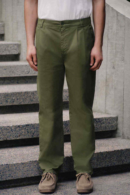 Olive green straight-leg trousers with side pockets and subtle cuffs