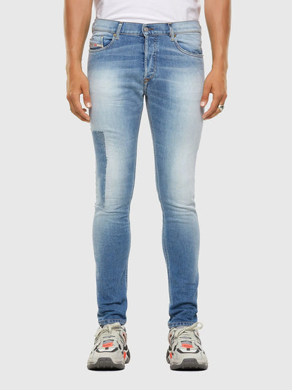 Blue denim jeans, straight slim legs, front view with whiskering and seam details