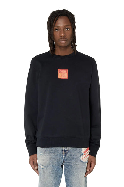 Black crewneck sweatshirt with small red logo patch at chest