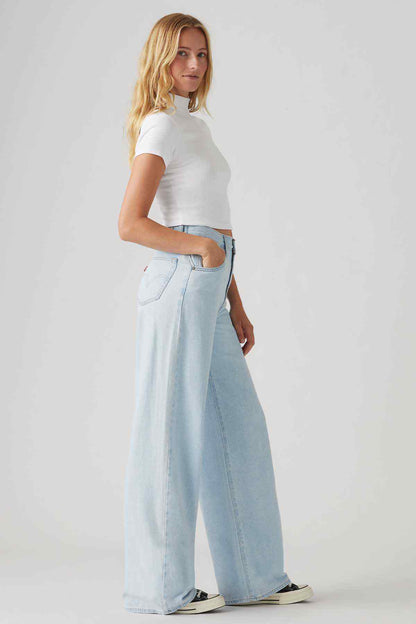 Light indigo wide-leg jeans with belt loops and subtle whiskering.