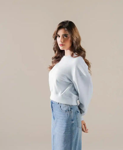Light blue fitted sweatshirt side view with pocket detail and long sleeves