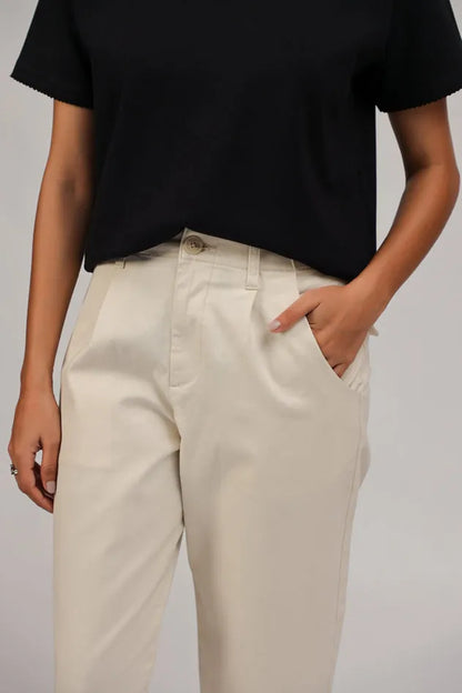 Ecru cropped trousers detail view with front pockets and button closure