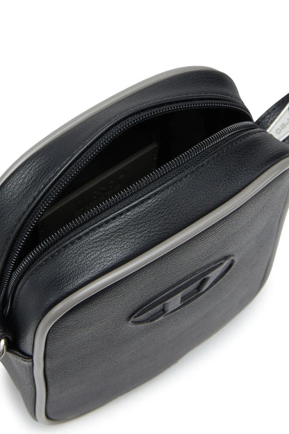 Diesel black mini crossbody bag, zipper opening and logo detail close-up