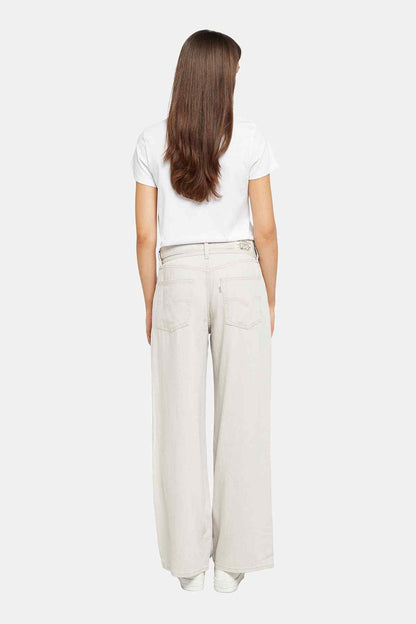 Levi's white graphic T-shirt and off-white wide-leg jeans, back view