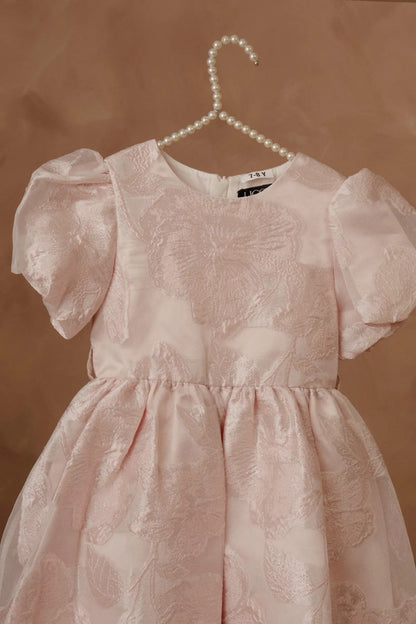 Light pink girls dress with puff sleeves and allover textured animal motif
