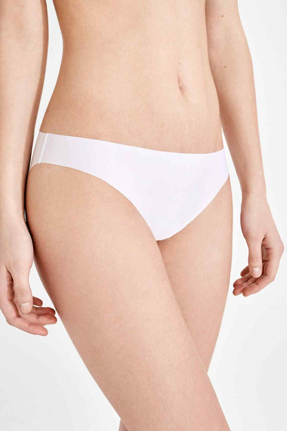 White bikini panties on model, mid-rise brief with smooth edges