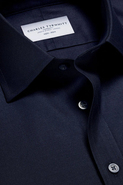 Charles Tyrwhitt dress shirt collar label and dark blue button close-up