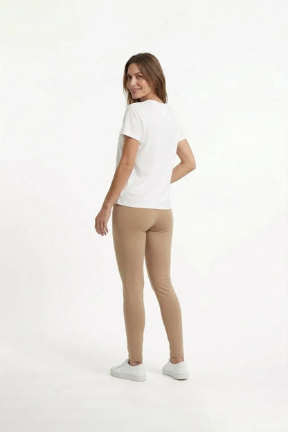 Beige slim-fit ankle pants, side view, elastic waistband
