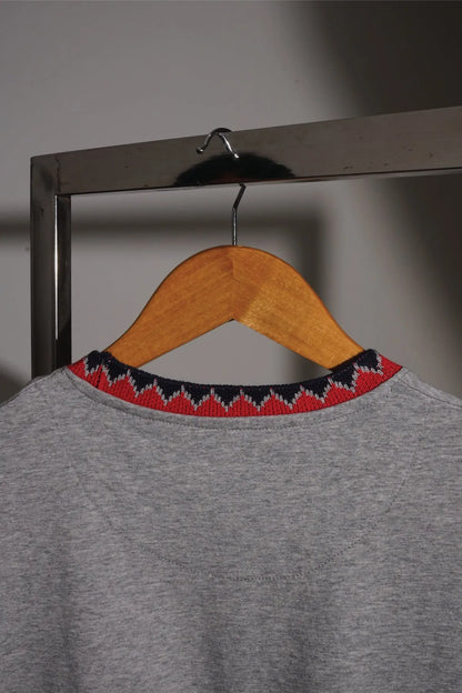 Grey short-sleeve T-shirt with red and black patterned crew neck trim