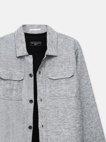 Grey long-sleeve button-up shirt with flap chest pockets and brand logo, close-up