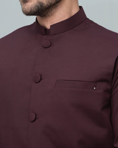 Dark maroon waistcoat close-up: stand collar, round buttons, chest pocket
