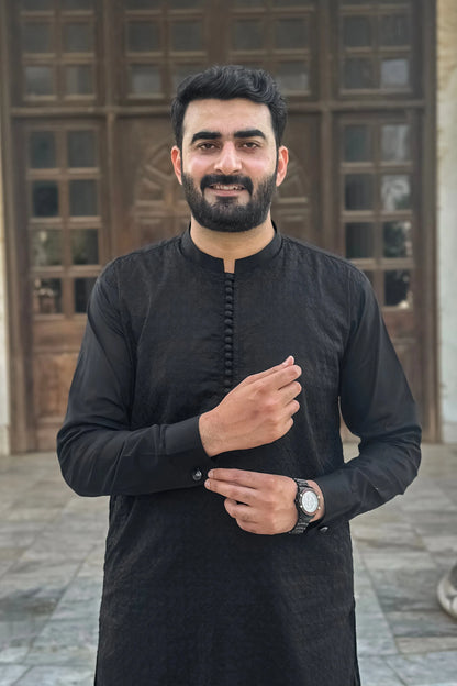 Men's black kurta with long sleeves and button front placket