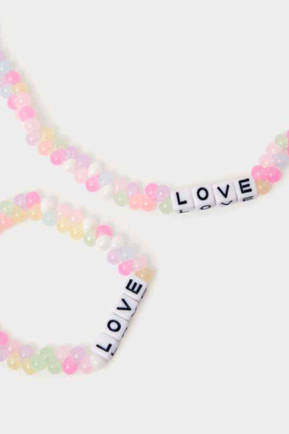 Pastel beaded necklace with black 'LOVE' letter beads and pink heart accents