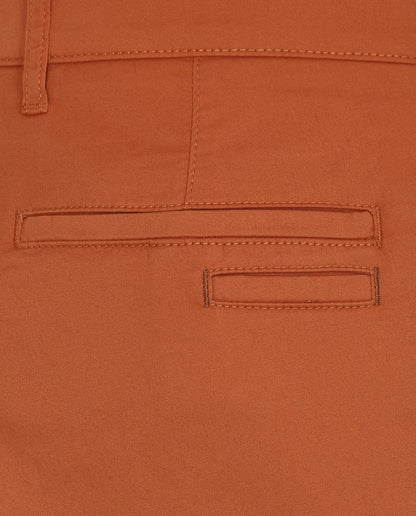 Orange pants belt loops and stitched coin-pocket flap, close-up