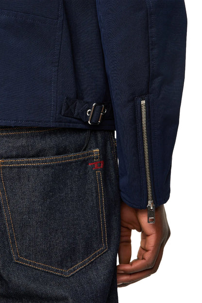 Close-up of dark blue jacket sleeve cuff with zipper pocket and snap placket