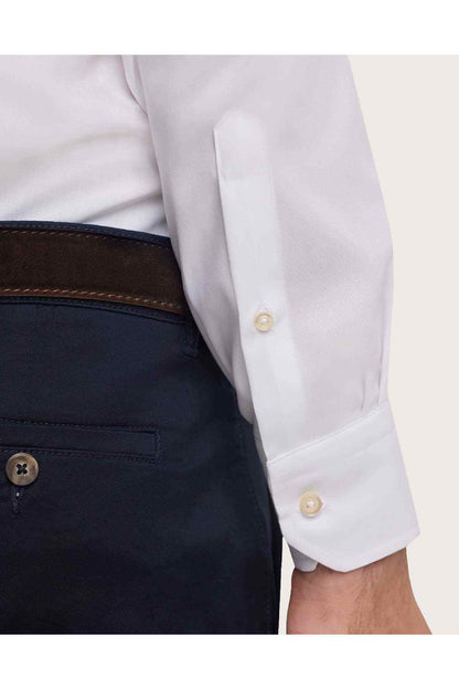 White dress shirt cuff with gold-tone buttons and single-button detail