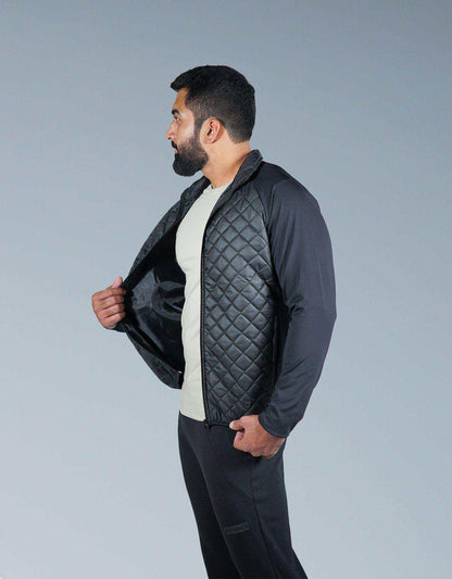 Black quilted zip-up jacket with diamond pattern, side profile