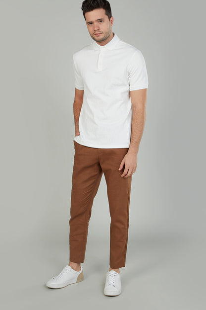 Brown slim-fit chino pants, belt loops, and tapered leg opening