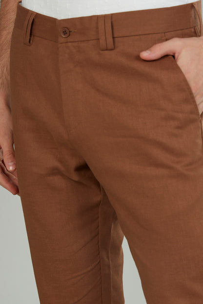 Brown chino pants close-up of waistband with button and belt loops
