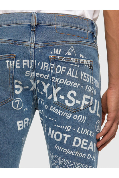 Blue denim jeans with oversized printed text graphic on the back leg.