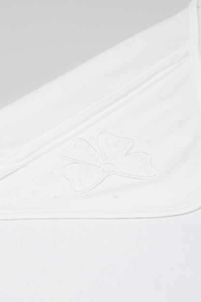 White baby blanket close-up of embroidered floral applique on corner
