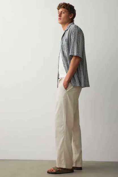 Men's striped short-sleeve shirt with cream wide-leg trousers