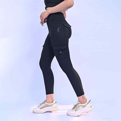 Women's black cargo leggings with side utility pockets, ankle length.
