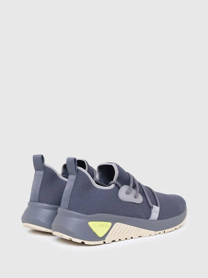 Blue athletic sneaker heel and side profile with lace eyelets and logo patch