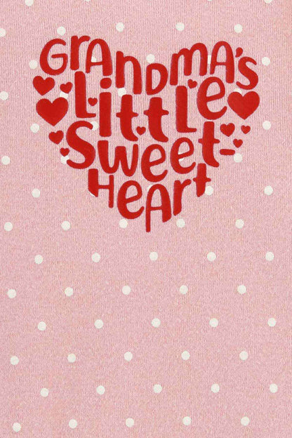 Pink fabric close-up with 'Grandma's Little Sweet Heart' text and red heart icons
