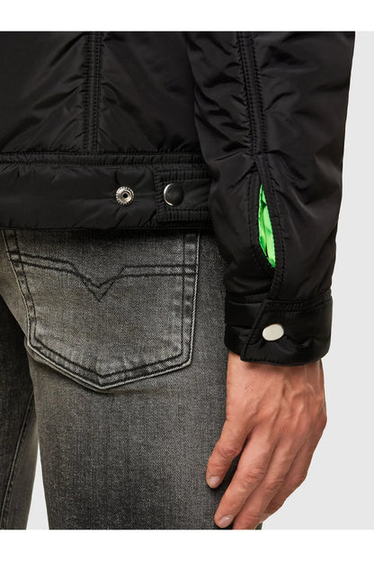 Diesel black jacket detail with flap chest pocket, snap cuff, green lining accent.