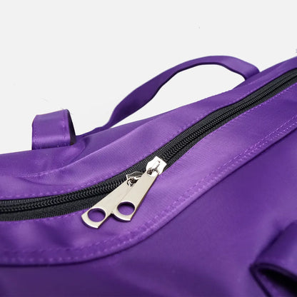 Close-up of purple tote bag zipper pull on top panel