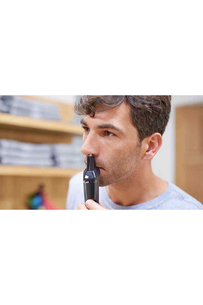 PHILIPS black trimmer positioned on a man’s cheek area during grooming