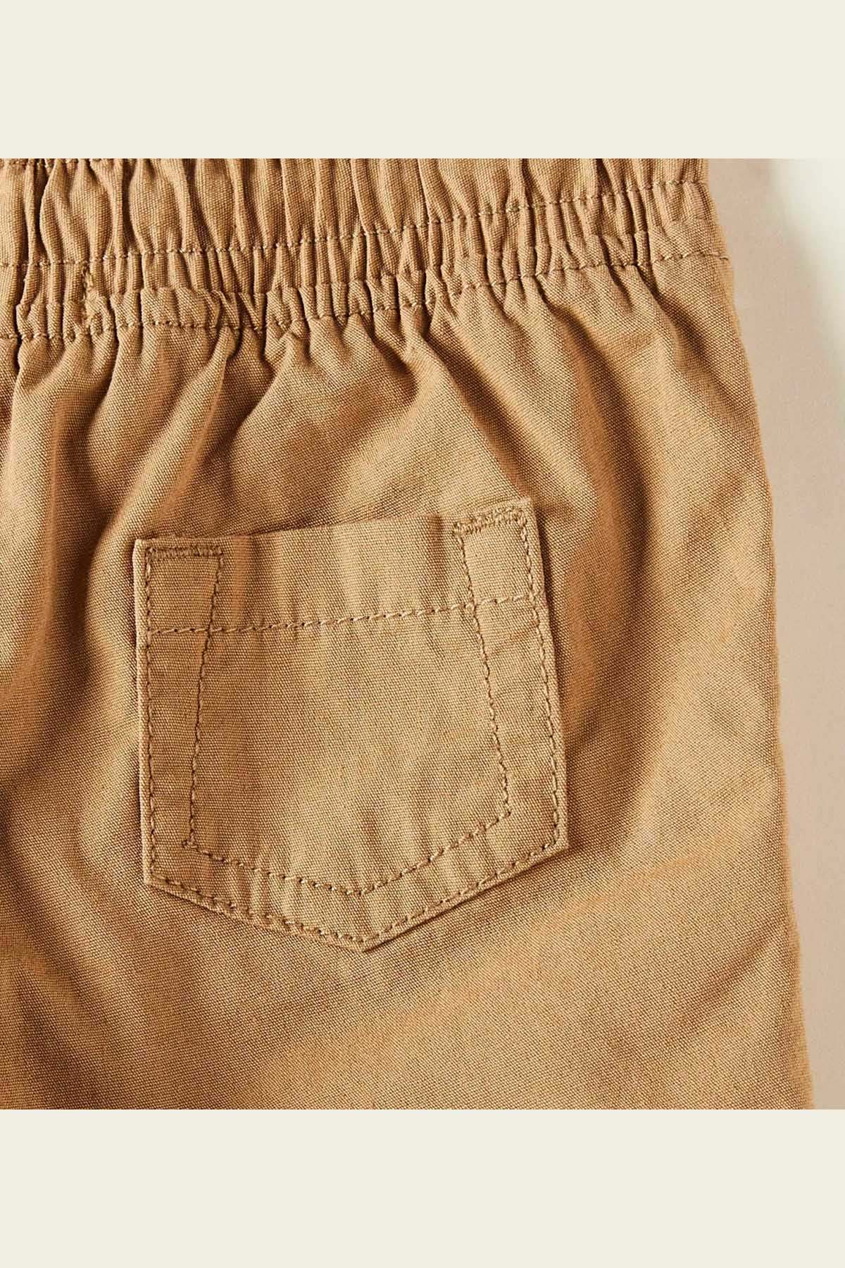 Brown baby shorts with front patch pocket and stitched seams