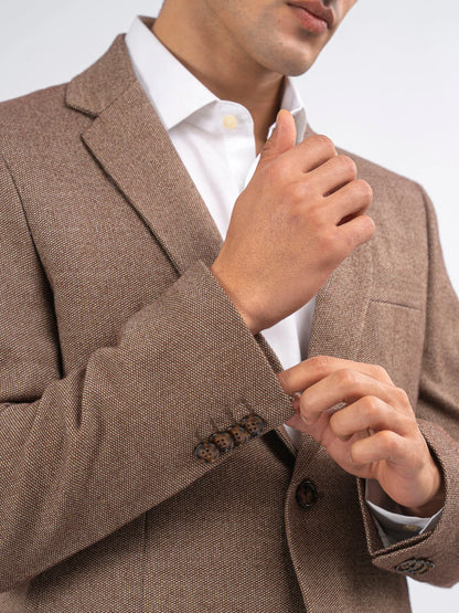 Brown blazer lapel and sleeve cuff detail with button and textured weave