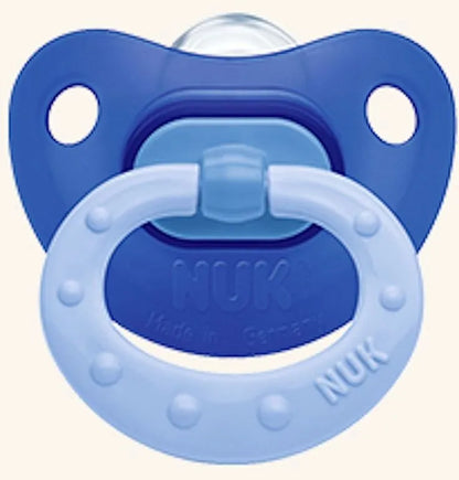 Light blue silicone baby pacifier with dark blue guard and Nuk logo on rim