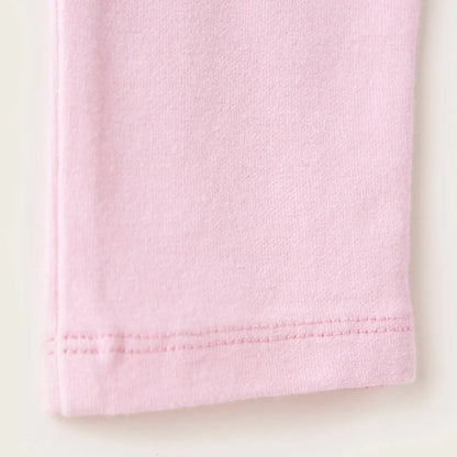Pink baby pants fabric close-up with stitched cuff hem