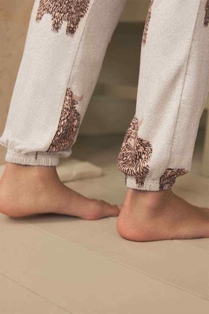 Oatmeal printed jogger pants with ribbed cuffs and dog print at the ankles