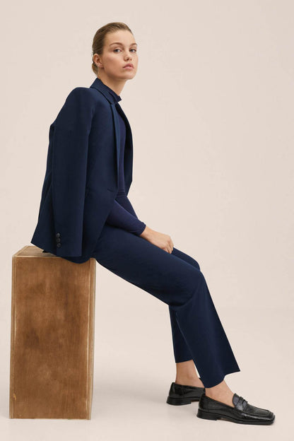 Dark navy tailored trousers with straight hem and belt loop detail, side view
