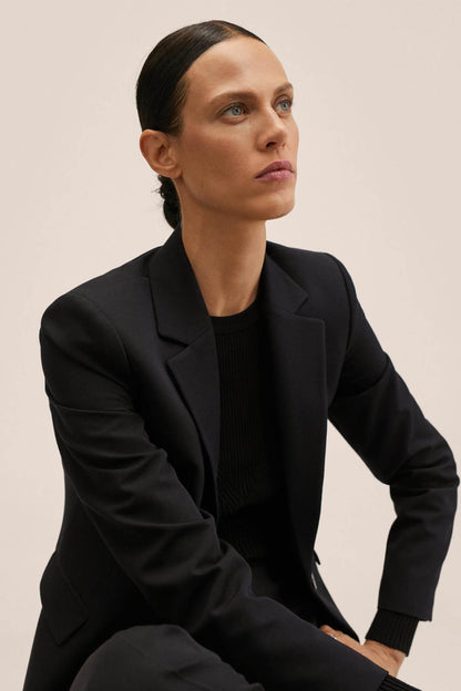 Black tailored blazer with lapels and black sleeveless top