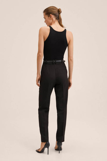 Black sleeveless top and high-waisted trousers with belt loops